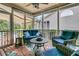 Inviting sunroom with comfortable seating, ceiling fan, and vibrant leaf-patterned rug at 134 Etiwan Park St, Charleston, SC 29492
