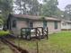 Simple single-story home showcasing a wooden deck, weathered exterior and minimal landscaping in the backyard at 137 Droze Rd, Summerville, SC 29483