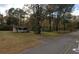 Street view of the home with a covered porch surrounded by mature trees at 137 Droze Rd, Summerville, SC 29483