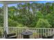 Relaxing balcony offers outdoor seating and serene views of the surrounding trees and landscape at 1454 Carradale Ln, Mount Pleasant, SC 29466