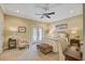 Cozy bedroom with neutral tones, ceiling fan, french doors to balcony, and comfortable sitting area at 1454 Carradale Ln, Mount Pleasant, SC 29466
