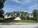 Clubhouse boasts pristine landscaping, palm trees, a grand staircase, and an American flag at 1454 Carradale Ln, Mount Pleasant, SC 29466