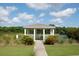 A gazebo on a cloudy day surrounded by some green shrubbery and a sidewalk to reach it at 1454 Carradale Ln, Mount Pleasant, SC 29466