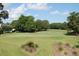 A beautiful golf course is surrounded by green trees under a bright blue sky with some clouds at 1454 Carradale Ln, Mount Pleasant, SC 29466