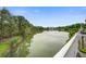 Scenic view of a calm lake surrounded by lush green trees, showcasing the property's waterfront appeal at 1454 Carradale Ln, Mount Pleasant, SC 29466