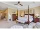 Comfortable main bedroom featuring a four-poster bed, sitting area, and tasteful decor at 1454 Carradale Ln, Mount Pleasant, SC 29466