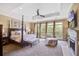 Spacious main bedroom with a tray ceiling, fireplace, and sitting area with natural light at 1454 Carradale Ln, Mount Pleasant, SC 29466