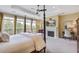 Bright main bedroom with a four-poster bed, fireplace, and large windows at 1454 Carradale Ln, Mount Pleasant, SC 29466