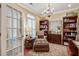 Cozy home office featuring hardwood floors, custom bookshelves and a decorative chandelier at 1454 Carradale Ln, Mount Pleasant, SC 29466