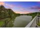 Breathtaking sunset view of the serene pond, complete with lush greenery and tranquil waters at 1454 Carradale Ln, Mount Pleasant, SC 29466