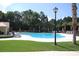 A beautiful clear blue swimming pool is surrounded by plenty of lounge chairs and greenery at 1454 Carradale Ln, Mount Pleasant, SC 29466
