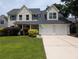 Charming two-story home with a manicured lawn, and a two-car garage at 164 Historic Dr, Mount Pleasant, SC 29464