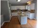 Bright kitchen with white cabinets, an island, granite countertops, and stainless appliances at 164 Historic Dr, Mount Pleasant, SC 29464