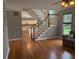 Comfortable living room with staircase and hardwood floors, adjacent to an eat-in kitchen at 164 Historic Dr, Mount Pleasant, SC 29464