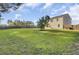 Large grassy backyard with a privacy fence, a young tree, and a view of the home's exterior at 165 Clydesdale Cir, Summerville, SC 29486