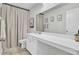 Well-lit bathroom featuring a spacious vanity with ample counter space and neutral-toned shower curtain at 165 Clydesdale Cir, Summerville, SC 29486