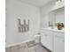 Bathroom featuring dual sinks, toilet, towel rack, tile floors, and a white cabinet at 165 Clydesdale Cir, Summerville, SC 29486