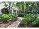 Inviting clubhouse entrance framed by palm trees, landscaping, and a brick walkway at 1755 Central Park Rd # 9103, Charleston, SC 29412