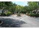 Entrance to the community with black metal gates, surrounded by lush greenery and mature trees at 1755 Central Park Rd # 9103, Charleston, SC 29412