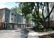 View of the building's exterior with garage parking and a sidewalk at 1755 Central Park Rd # 9103, Charleston, SC 29412