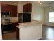 Cozy kitchen featuring stainless steel appliances, granite countertops, and wood cabinets at 1755 Central Park Rd # 9103, Charleston, SC 29412