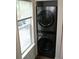 Laundry area with stacked washer and dryer unit next to a bright window at 1755 Central Park Rd # 9103, Charleston, SC 29412