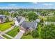 Beautiful aerial view of a brick house and landscaped yard located on a scenic pond at 1868 Palmetto Isle Dr, Mount Pleasant, SC 29466