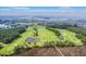 Scenic aerial view of a golf course, marshlands, and waterway with blue skies at 1868 Palmetto Isle Dr, Mount Pleasant, SC 29466