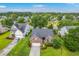 Gorgeous aerial view of a landscaped house next to a pond surrounded by lush trees at 1868 Palmetto Isle Dr, Mount Pleasant, SC 29466