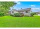 Spacious backyard showcases the home's deck and landscaping, complemented by a green lawn at 1868 Palmetto Isle Dr, Mount Pleasant, SC 29466