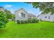Manicured backyard features a well-kept lawn and tasteful landscaping, enhancing home's curb appeal at 1868 Palmetto Isle Dr, Mount Pleasant, SC 29466