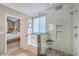 Modern bathroom with glass shower, soaking tub, and pebble-stone shower floor at 1868 Palmetto Isle Dr, Mount Pleasant, SC 29466