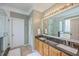 Bathroom featuring a double vanity with granite countertop and decorative mirror at 1868 Palmetto Isle Dr, Mount Pleasant, SC 29466