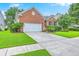 Charming single-story brick home with well-manicured lawn and attached two-car garage at 1868 Palmetto Isle Dr, Mount Pleasant, SC 29466