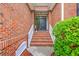 Inviting brick stairway leads to a welcoming front door with decorative plants and stylish details at 1868 Palmetto Isle Dr, Mount Pleasant, SC 29466