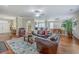 Open-concept living and dining area with hardwood floors and comfortable leather seating at 1868 Palmetto Isle Dr, Mount Pleasant, SC 29466
