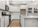 Modern kitchen with white cabinetry, stainless steel appliances, and a functional center island at 198 Winding Branch Dr, Summerville, SC 29486