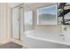 Clean bathroom with a shower, tub, large window, and modern fixtures offers a relaxing and functional space at 199 Meadow Wood Rd, Summerville, SC 29486