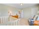 Cozy bedroom showcases a crib, comfortable seating, and a changing table for a functional, inviting space at 199 Meadow Wood Rd, Summerville, SC 29486