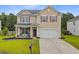 Inviting two-story house with a red front door, covered porch, and manicured front yard at 199 Meadow Wood Rd, Summerville, SC 29486