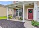Quaint front porch featuring rocking chairs, plants, and a decorative wreath on the door at 199 Meadow Wood Rd, Summerville, SC 29486
