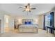 A spacious main bedroom with a king-sized bed, ceiling fan, and access to a bathroom offers comfort and convenience at 199 Meadow Wood Rd, Summerville, SC 29486