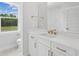 Bright bathroom boasts double vanity with modern fixtures and a large mirror reflecting the tiled shower at 2004 Sea Water Dr, Charleston, SC 29412