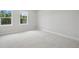 This is a light, neutral bedroom with two windows and plush carpeting at 2004 Sea Water Dr, Charleston, SC 29412