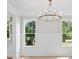 Elegant dining room with modern chandelier, hardwood floors, and ample natural light at 2004 Sea Water Dr, Charleston, SC 29412