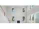 Spacious living room with large windows, fireplace, and high ceilings at 2004 Sea Water Dr, Charleston, SC 29412