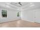 Serene main bedroom featuring tray ceilings, recessed lighting, and large windows at 2004 Sea Water Dr, Charleston, SC 29412
