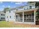 A screened-in porch is on the back of a new two-story construction with a well-manicured lawn at 2006 Riverbend Dr, Charleston, SC 29412