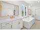 Luxurious bathroom featuring a soaking tub, and vanity at 2006 Riverbend Dr, Charleston, SC 29412