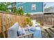 Comfortable back deck area perfect for relaxing with a sofa and chair set at 202 Fishburne St, Charleston, SC 29403